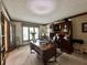 Well-appointed office space with a large desk, built-in shelving, and natural light at 5205 Mosswood Ct, Indianapolis, IN 46254