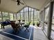 Enclosed patio with vaulted ceilings, and an outdoor dining set with seating at 5205 Mosswood Ct, Indianapolis, IN 46254