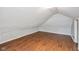 Attic featuring wood laminate flooring and bright natural light at 5209 Melrose Ave, Indianapolis, IN 46241