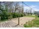 Backyard featuring a sandbox area, deck and lush green trees at 5209 Melrose Ave, Indianapolis, IN 46241