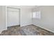 Cozy room featuring durable flooring, a window, and closet at 5209 Melrose Ave, Indianapolis, IN 46241