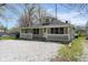 Charming single-story home featuring a cozy front porch and a gravel driveway at 5209 Melrose Ave, Indianapolis, IN 46241