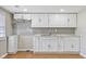 Functional kitchen featuring white cabinets, and a stylish gray backsplash at 5209 Melrose Ave, Indianapolis, IN 46241