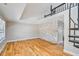 Bright living room boasting hardwood floors, stone wall, and spiral staircase at 5209 Melrose Ave, Indianapolis, IN 46241