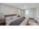 Serene bedroom featuring neutral tones, plush bedding, and a spacious closet at 5209 Melrose Ave, Indianapolis, IN 46241