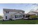 A backyard featuring a covered patio, lush greenery, and the home's siding, perfect for outdoor relaxation at 5529 W Turnbuckle Pl, McCordsville, IN 46055