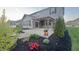 Charming backyard with a cozy covered patio, beautiful landscaping, and a well-manicured lawn at 5529 W Turnbuckle Pl, McCordsville, IN 46055