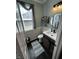 View of decorated bathroom with custom wall decorations, toilet, wood style sink and modern fixtures at 5529 W Turnbuckle Pl, McCordsville, IN 46055