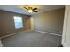 Neutral bedroom with ceiling fan and natural light from the window at 5529 W Turnbuckle Pl, McCordsville, IN 46055