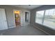 Neutral bedroom with closet and bathroom access, and natural light from the large window at 5529 W Turnbuckle Pl, McCordsville, IN 46055