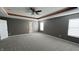 Bright, neutral bedroom has a tray ceiling and plush carpet at 5529 W Turnbuckle Pl, McCordsville, IN 46055