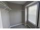 Window-lit walk-in closet features gray carpet and shelving at 5529 W Turnbuckle Pl, McCordsville, IN 46055