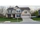 Charming two-story home with a manicured lawn, brick accents, and a two-car garage, presenting an inviting curb appeal at 5529 W Turnbuckle Pl, McCordsville, IN 46055
