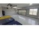 Spacious garage with epoxy flooring, ample lighting, and garage door at 5529 W Turnbuckle Pl, McCordsville, IN 46055