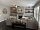 Living room features fireplace with custom wall decorations, grey sectional sofa, and ceiling fan at 5529 W Turnbuckle Pl, McCordsville, IN 46055