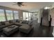 Spacious living room flows into the kitchen with white cabinets, hardwood floors, and stainless appliances at 5529 W Turnbuckle Pl, McCordsville, IN 46055