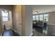View of the living room with large sectional couch and view into bathroom with toilet and sink at 5529 W Turnbuckle Pl, McCordsville, IN 46055