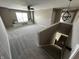 Loft area with a built-in window seat, offering a cozy reading nook and view of the neighborhood at 5529 W Turnbuckle Pl, McCordsville, IN 46055