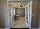 Bright home office with French doors, neutral paint, and marble floors, perfect for a productive workspace at 5529 W Turnbuckle Pl, McCordsville, IN 46055