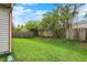 This backyard has a grass lawn and a wooden fence, providing privacy and space for outdoor activities at 5666 Ensley Ct, Indianapolis, IN 46254