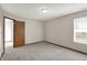 This bedroom has neutral walls and carpeting, and a large window for ample natural light at 5666 Ensley Ct, Indianapolis, IN 46254