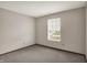 This bedroom has neutral walls, carpeting, and a large window for ample natural light at 5666 Ensley Ct, Indianapolis, IN 46254