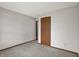 This bedroom has neutral walls and carpeting, and a door leading to another room at 5666 Ensley Ct, Indianapolis, IN 46254