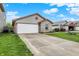 Lovely one-story house featuring a two-car garage, brick detail, driveway, and green lawn at 5666 Ensley Ct, Indianapolis, IN 46254