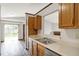 Efficient kitchen with stainless sink, and pass-through to the combined living and dining area at 5666 Ensley Ct, Indianapolis, IN 46254