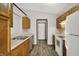 Bright kitchen featuring stainless steel appliances, wood cabinets, and new plank flooring at 5666 Ensley Ct, Indianapolis, IN 46254