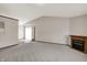 Spacious living room featuring neutral carpet, fireplace, and view of the back door entrance at 5666 Ensley Ct, Indianapolis, IN 46254