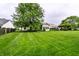 Lush backyard with mature trees, grass and fenced perimeter at 5845 Arrowleaf Ln, Carmel, IN 46033