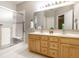 Bright bathroom with a double sink vanity and glass enclosed shower at 5845 Arrowleaf Ln, Carmel, IN 46033