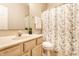 Bright bathroom featuring a vanity sink and floral shower curtain at 5845 Arrowleaf Ln, Carmel, IN 46033