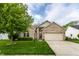 Inviting home with a brick facade, lush green lawn, and attached garage, perfect for Gathering living at 5845 Arrowleaf Ln, Carmel, IN 46033