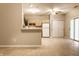 Modern kitchen open to the living area, featuring wood cabinets, white appliances, and a sliding glass door at 5845 Arrowleaf Ln, Carmel, IN 46033