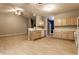Open-concept kitchen with light wood cabinets, white appliances, and seamless flow to living and dining spaces at 5845 Arrowleaf Ln, Carmel, IN 46033