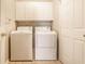 Functional laundry room with washer, dryer and cabinetry at 5845 Arrowleaf Ln, Carmel, IN 46033