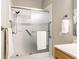 Modern shower with glass door and convenient grab bars at 5845 Arrowleaf Ln, Carmel, IN 46033