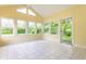 Bright sunroom with yellow walls, tile floors and sliding doors to the yard at 5845 Arrowleaf Ln, Carmel, IN 46033
