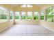 Bright sunroom with yellow walls, tile floors and many windows at 5845 Arrowleaf Ln, Carmel, IN 46033