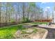 Backyard featuring a grass yard and patio with chairs, enclosed by a wooden fence at 5924 Skyward Ln, Indianapolis, IN 46234