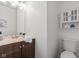 Well-lit bathroom featuring a wood vanity and toilet at 5924 Skyward Ln, Indianapolis, IN 46234