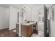 Well-lit bathroom featuring a vanity with a sink and a view into an adjacent carpeted room at 5924 Skyward Ln, Indianapolis, IN 46234