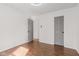 An empty bedroom featuring hardwood floors and two doors at 5924 Skyward Ln, Indianapolis, IN 46234