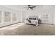 Inviting bedroom with plush carpeting, an updated ceiling fan, and large windows, creating a relaxing atmosphere at 5924 Skyward Ln, Indianapolis, IN 46234
