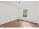 A bright bedroom with hardwood floors and a large window at 5924 Skyward Ln, Indianapolis, IN 46234