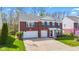 Charming two-story brick home with a spacious driveway, two-car garage, and well-maintained lawn at 5924 Skyward Ln, Indianapolis, IN 46234