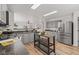 A modern kitchen with gray cabinets, stainless steel appliances, and a mobile island at 5924 Skyward Ln, Indianapolis, IN 46234