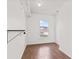 Walk-in closet with wood-look flooring, a window, and shelving at 5924 Skyward Ln, Indianapolis, IN 46234